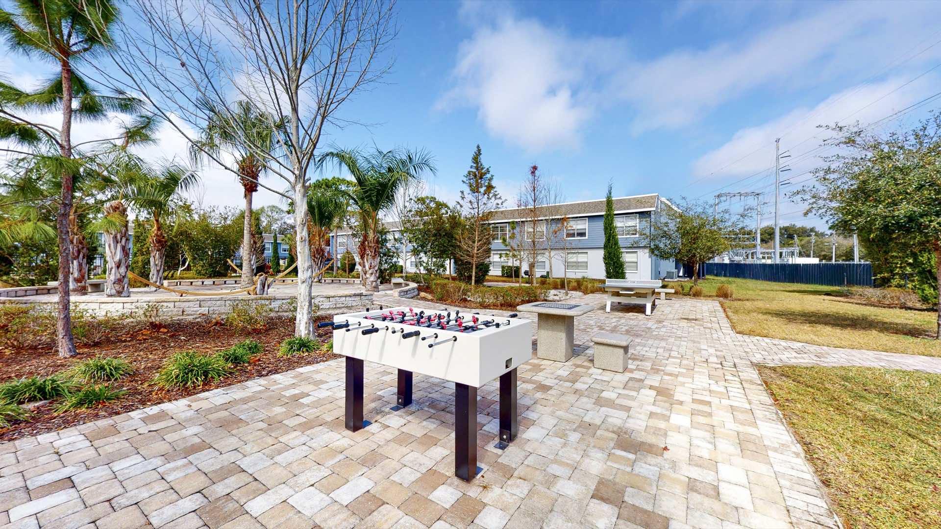 outdoor game area with wide, brick sidewalks and beautiful landscape