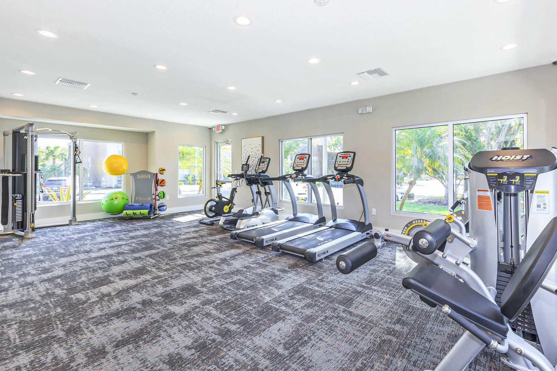 fitness center with modern machines, medicine balls and more