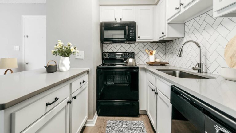 kitchen with modern white shaker cabinetry and wood-style flooring
